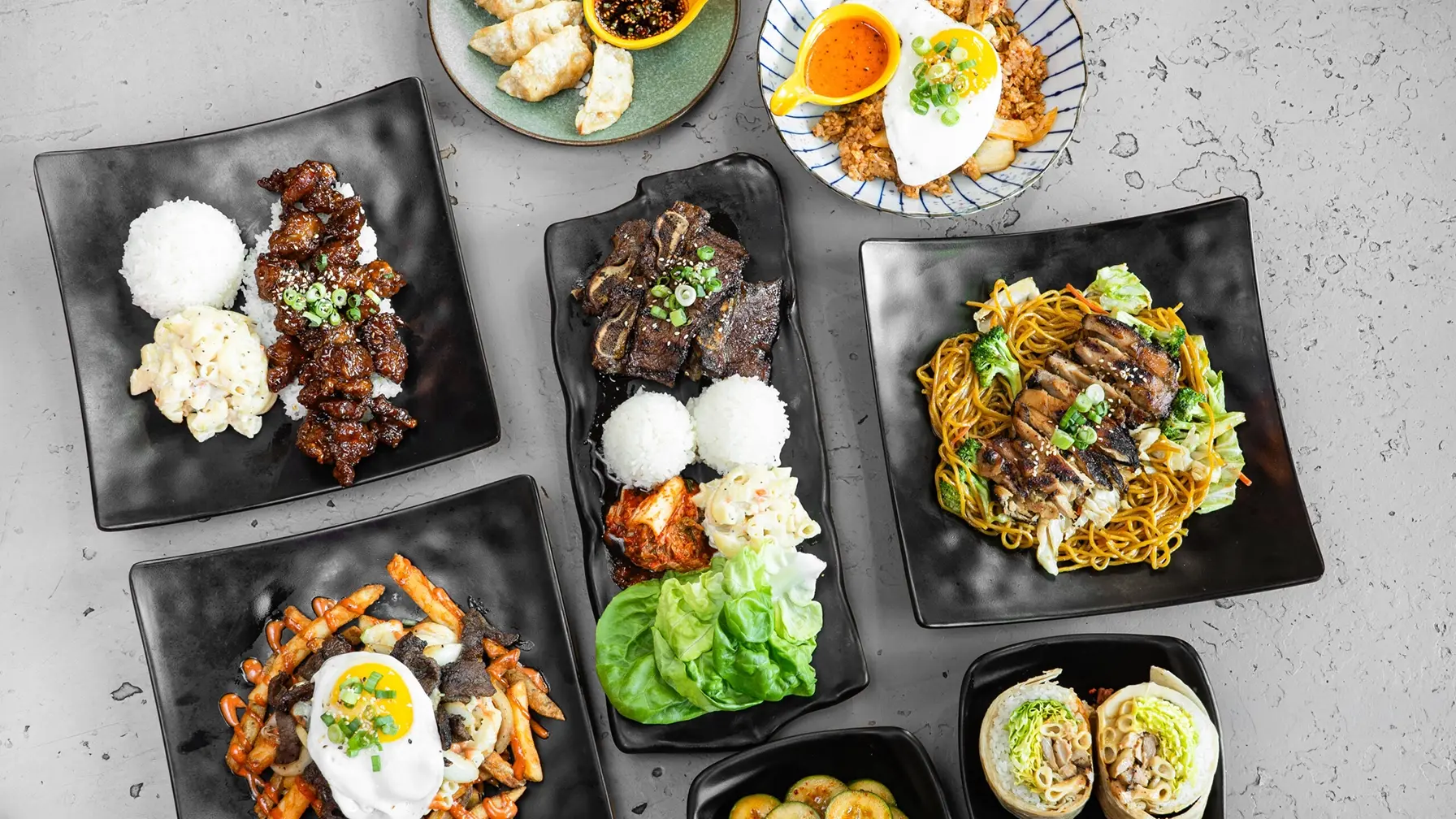 A spread of Que Dice dishes shared across the table